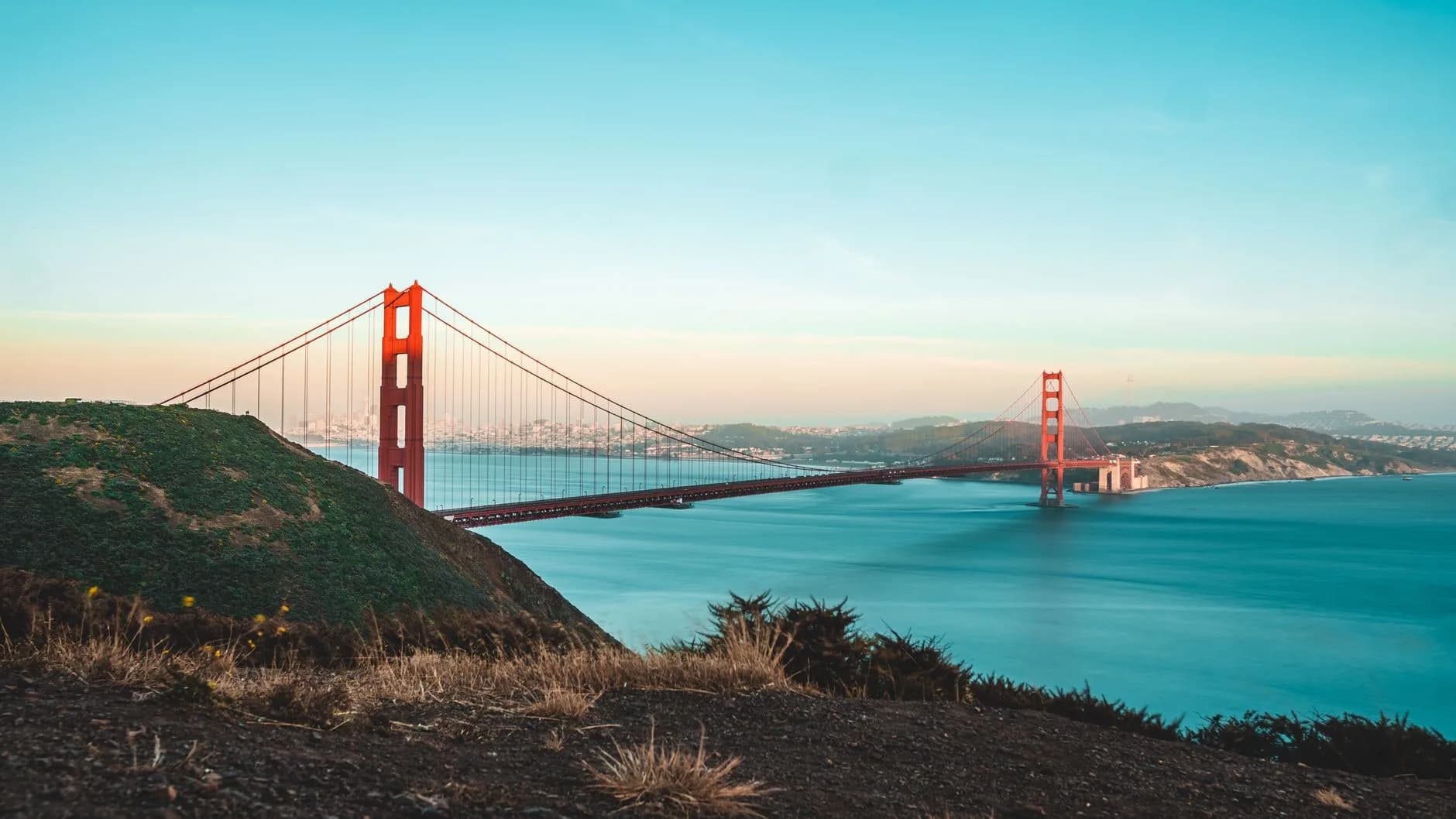 Stunning view of the Golden Gate Bridge during sunset, overlooking the ocean and shoreline.